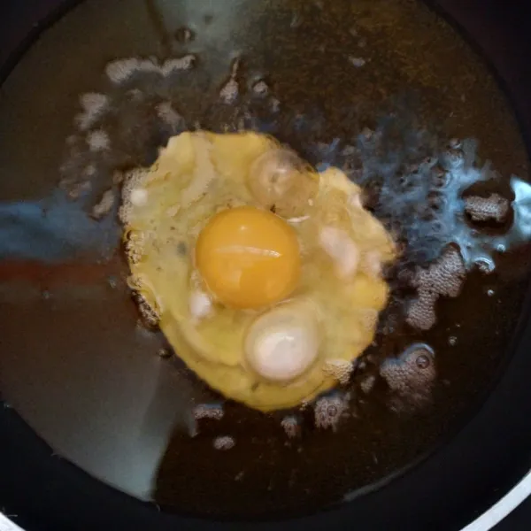 Ceplok telur sampai matang dan beri taburan garam.