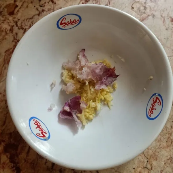 Parut bawang putih dan bawang merah.
