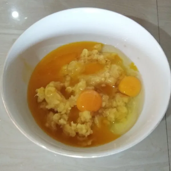 Masukan telur dan margarin cair (margarin pada suhu ruang dan tidak panas). Aduk dengan whisk hingga tercampur rata.