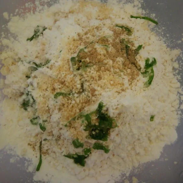 Masukkan tepung, tahu, daun bawang, kaldu dan merica,  garam, aduk rata. Tuangkan air panas perlahan hingga adonan menyatu.