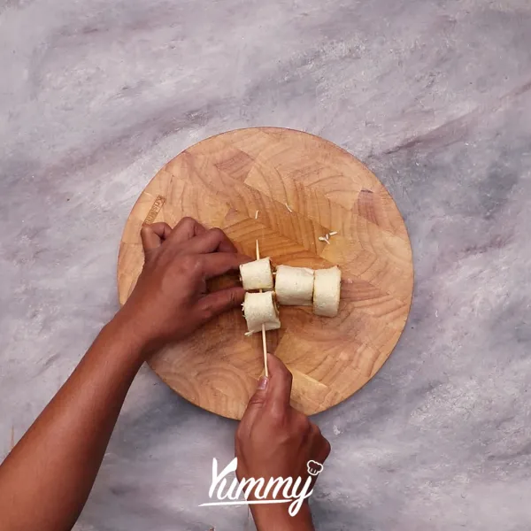 Tusuk roti yang telah digulung dengan tusuk sate.