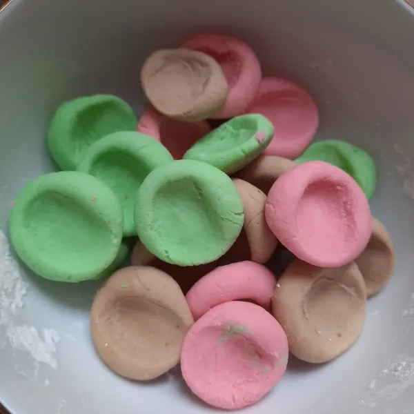 Ambil sedikit adonan. Bulatkan lalu tekan tengahnya dengan jempol. Lakukan hingga adonan habis.