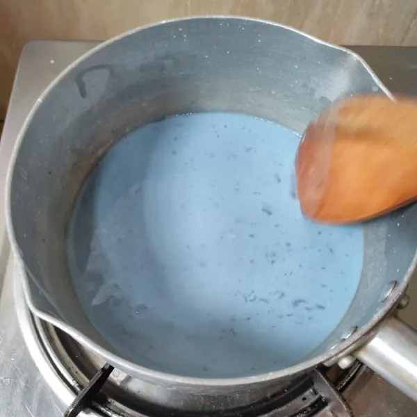 Kemudian masukkan campuran tepung kedalam air bunga telang, aduk rata tambahkan garam, lalu masak sambil diaduk hingga kalis. Angkat.