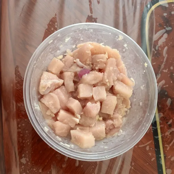 Marinate daging ayam dengan parutan bawang putih dan bawang merah. Lalu diamkan sekitar 30 menit.