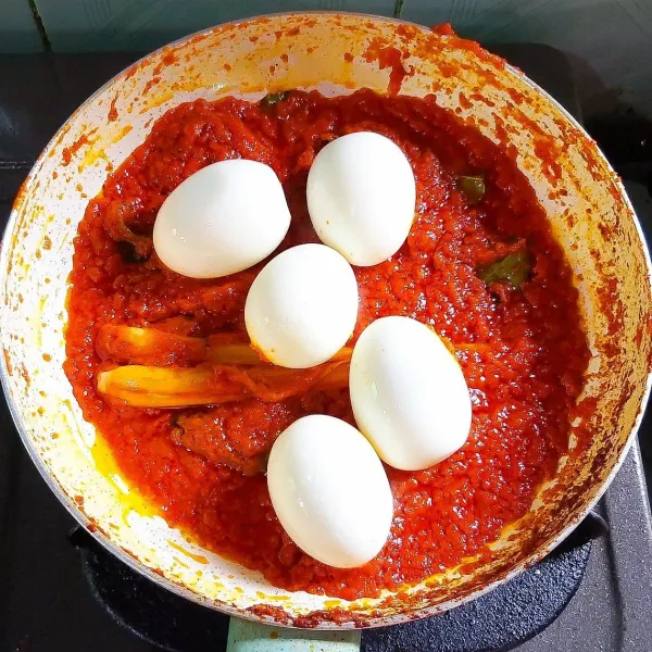 Tambahkan sedikit air agar tidak kering, kemudian masukan gula merah, kecap manis, garam dan penyedap rasa secukupnya. Masak hingga bumbu benar-benar matang, sampai berubah warna menjadi lebih gelap. Tes rasa bila sudah sesuai masukan telur yang sudah direbus, aduk rata sampai seluruh permukaan telur terbalut oleh bumbu. Matikan api dan siap disajikan!
