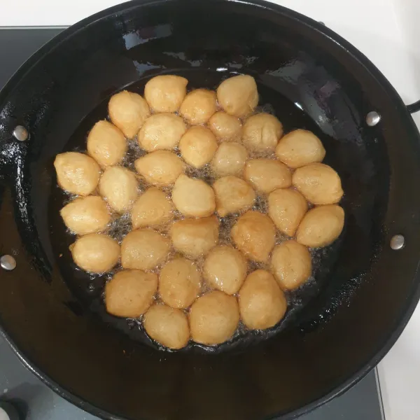 Goreng loukoumades sampai berwarna kuning keemasan, angkat dan tiriskan. Sajikan dengan topping gula kastor, bubuk kayu manis dan madu.