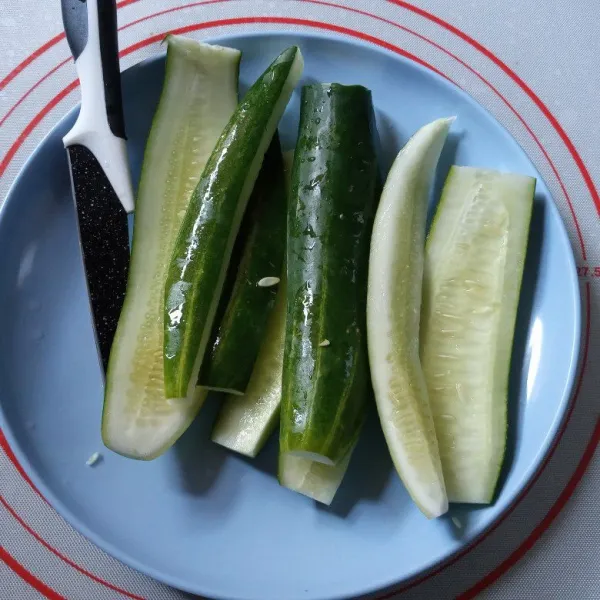 Cuci bersih timun lalu potong buang bijinya.