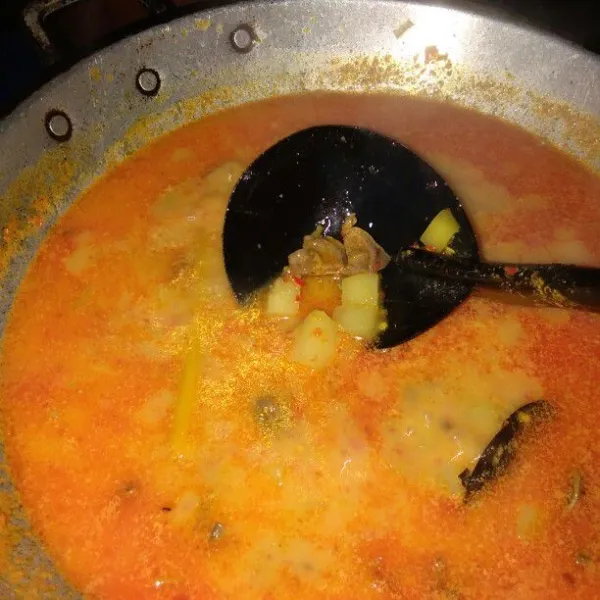 Masukkkan santan, kaldu bubuk, dan gula, lalu masak sampai mendidih dan kentang empuk. Koreksi rasa.