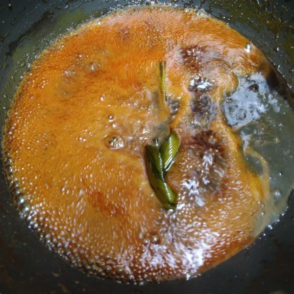 Dalam panci, masukkan gula, air, dan daun pandan. Masak hingga gula larut dan mengental.