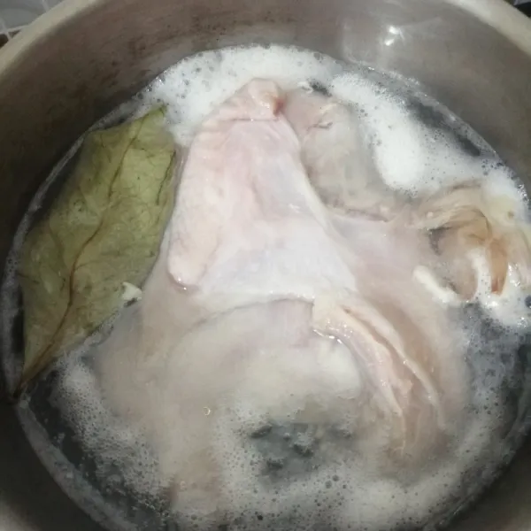 Cuci bersih ayam, lalu panaskan air di panci. Kalau sudah keluar gelembung kecil, masukkan ayam, daun salam, dan bawang putih yang sudah dgeprek. Masak sampai ayam matang.