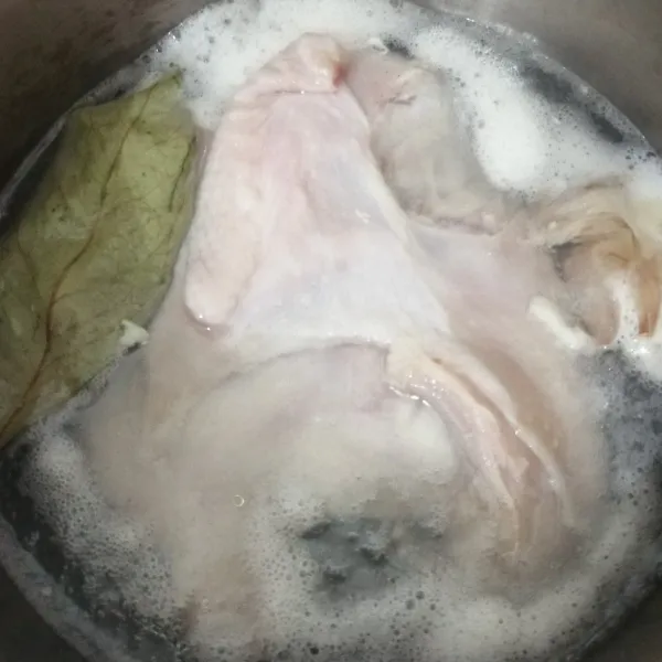 Rebus ayam dengan 2 siung bawang putih yang sudah digeprek dan daun salam sampai matang.