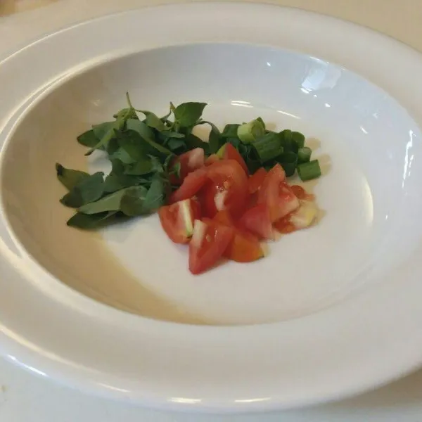 Letakan tomat, kemangi dan daun bawang dalam mangkuk beri siraman iga dan kuahnya.