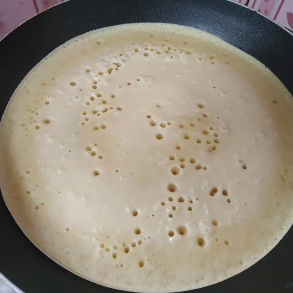 Panaskan teflon sampai benar-benar panas, olesi dengan sedikit margarin. Tuang adonan secukupnya, biarkan sampai berlubang-lubang dan matang.