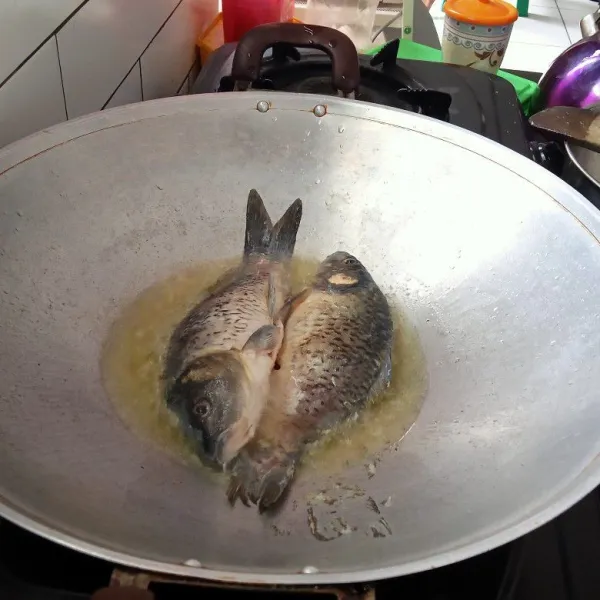 Cuci bersih ikan, lumuri dengan jeruk lemon, goreng ikan hingga kering