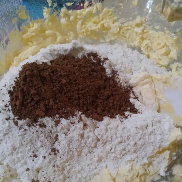 Masukan tepung terigu dan coklat bubuk, aduk dengan spatula hingga tercampur rata.
