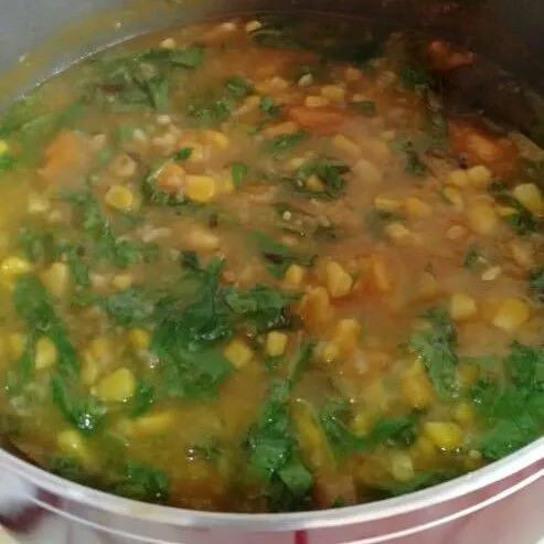 Tunggu airnya menyusut dan nasi matang. Tambahkan labu dan bayam. Aduk sebentar lalu matikan api. Beri kemangi dan aduk rata. Sajikan dengan ikan asin dan tempe goreng.