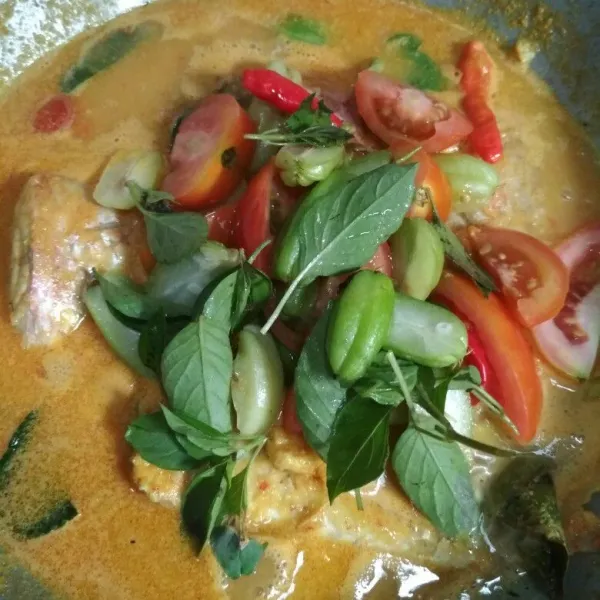 Tambahkan air, gula pasir, garam, dan kaldu bubuk. Aduk hingga rata. Koreksi rasa. Sesaat akan diangkat, tambahkan potongan tomat, belimbing sayur, kemangi dan cabe rawit. Aduk lalu matikan api.