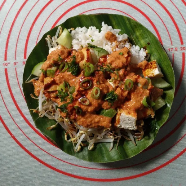 Tuang saus kacang, beri irisan daun bawang dan seledri. Tuang kecap manis secukupnya saja. Sajikan.