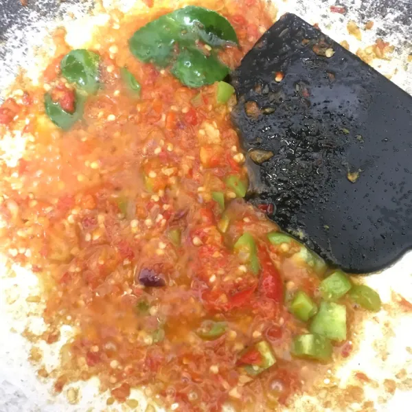 Siapkan wajan lalu tambahkan 5 sdm minyak tunggu minyak cukup panas lalu tumis bumbu sambal mercon dan tambahkan 2 lembar daun jeruk dan potongan-potongan dadu kecil tomat tunggu hingga wangi.