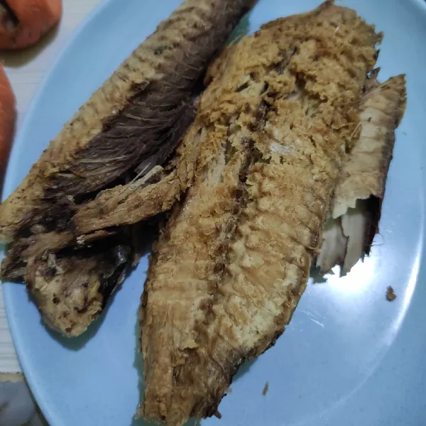 Siangi ikan tongkol dari duri dan kotoran, cuci bersih dan goreng.