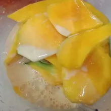 Masukkan 3 buah mangga lagi ke blender tambahkan susu evaporasi dan susu kental manis kemudian blender hingga lembut.