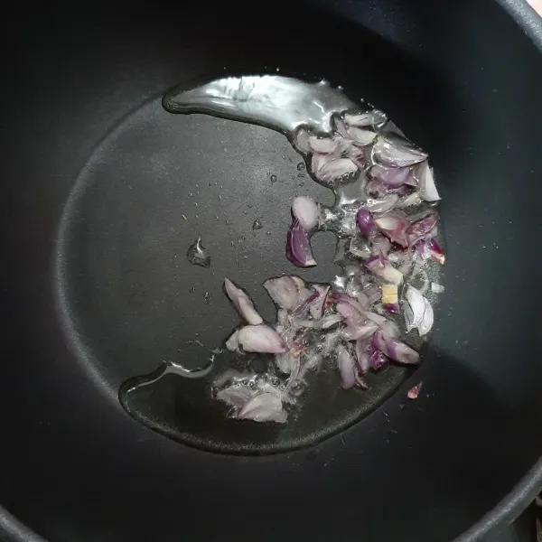 Masukkan irisan bawang merah ke dalam minyak, tumis hingga setengah layu.