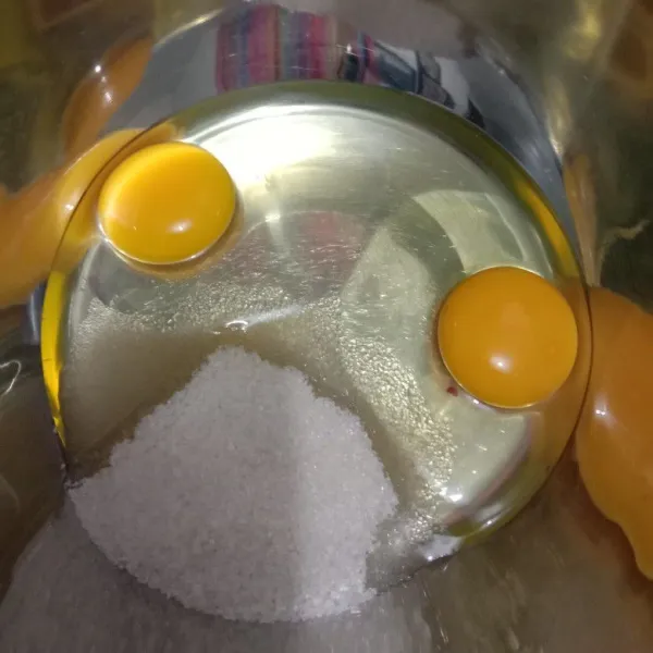 Kocok telur dan gula pasir dengan whisk hingga gula larut.