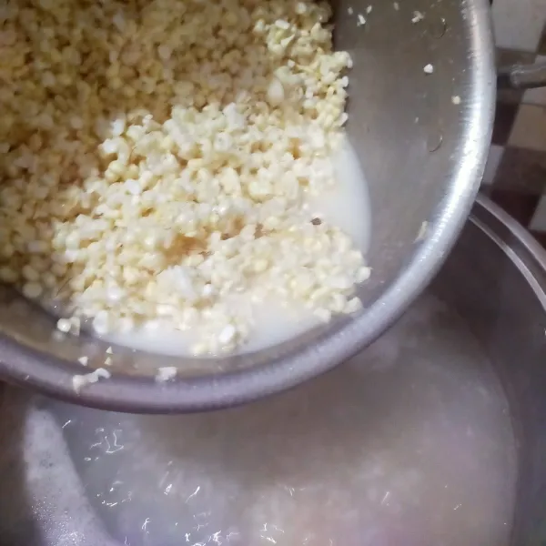 Setelah beras setengah matang, masukkan jagung.