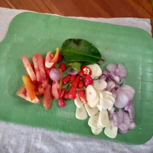 Siapkan irisan bawang merah, bawang putih, cabai rawit, tomat, dan daun jeruk utuh.