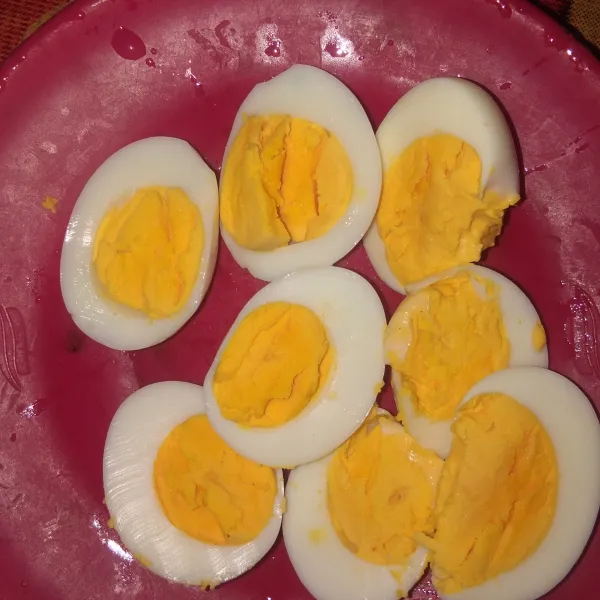 Belah telur rebus menjadi 2 bagian.