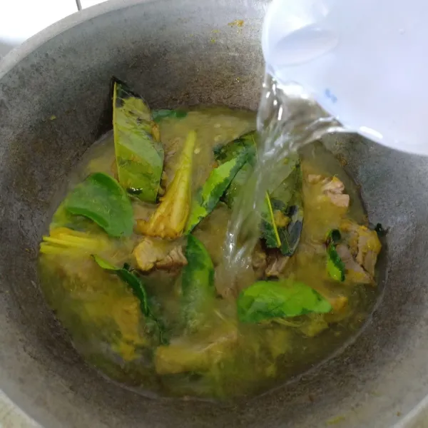 Tambahkan 500 ml air, diamkan dan aduk sesekali hingga air meresap, lalu masukkan tomat, kol, dan daun bawang. Tunggu sampai matang lalu sajikan.