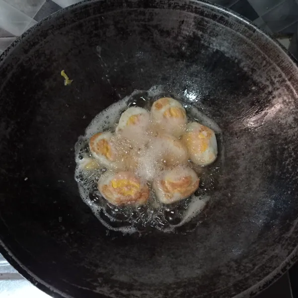 Kupas telur yang sudah direbus, belah jadi dua goreng sampai berkulit, cukup sekali balik.