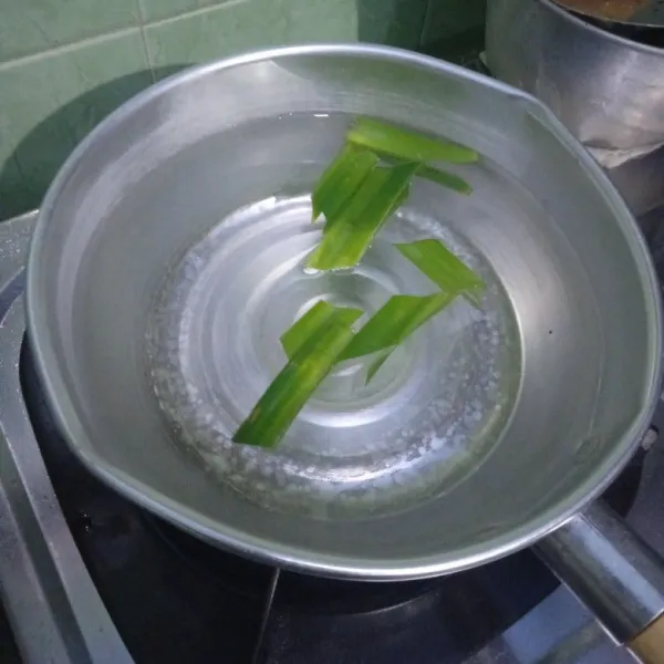 Rebus air bersama daun pandan yang sudah dipotong-potong.
