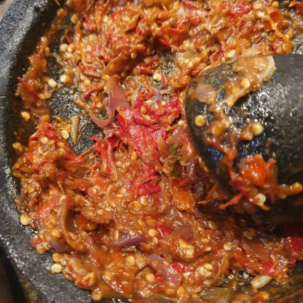 Setelah bumbu halus, masukkan terong kukus, sambil dibejek (uleg kasar).