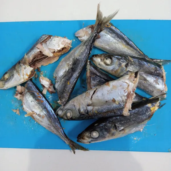 Siapkan ikan pindang. Cuci bersih. Kemudian potong jadi dua.