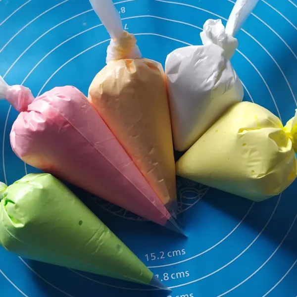 Bagi icing sugar menjadi berapa bagian, beri pewarna makanan, lalu masukan kedalam plastik segitiga