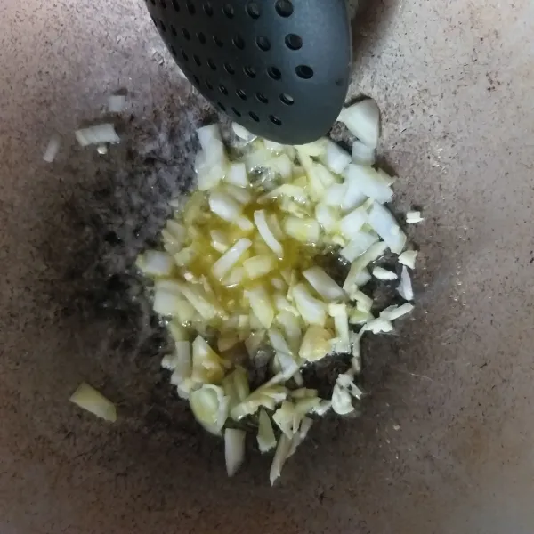 Cincang bawang bombai dan bawang putih, kemudian lelehkan margarin di wajan, dan tumis hingga harum.