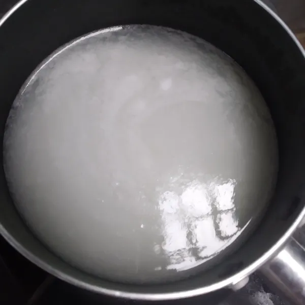 Panaskan air. Masukan tepung beras dan gula pasir hingga mengental membentuk pasta.