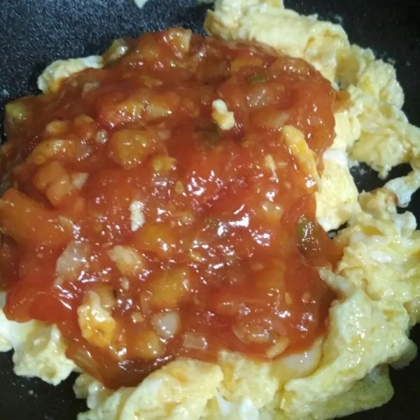 Masak telur hingga 3/4 matang, tuang saos tomat yang di masak tadi, aduk hingga tercampur rata