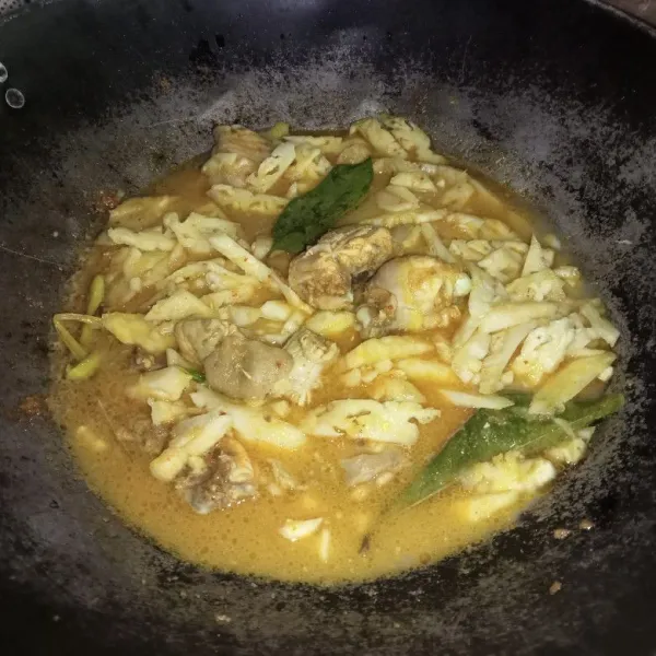 Masukkan nanas dan santan encer, masak hingga ayam matang.