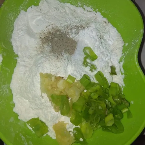 Campur jadi satu wadah tepung tapioka, tepung terigu, garam, lada, bawang putih yang sudah dihaluskan beserta potongan daun bawang.