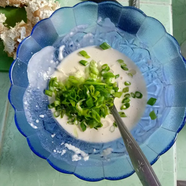 Campur tepung bumbu serbaguna dengan air dingin, aduk rata lalu beri potongan daun bawang, aduk lagi.