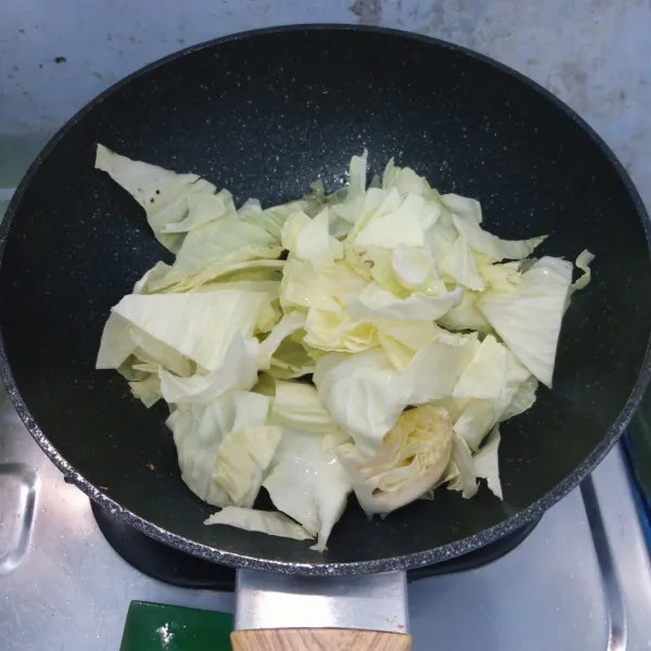 Goreng kubis sampai layu. Kemudian buang minyaknya.