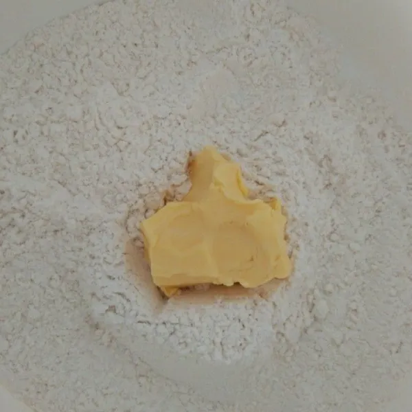 Dalam wadah campur tepung terigu, garam dan gula pasir aduk rata, masukan margarin uleni hingga bergerindil/berpasir.
