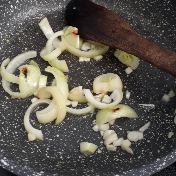 Panaskan minyak goreng lalu tumis bawang putih dan bawang bombay hingga harum.