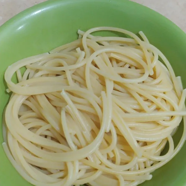 Rebus spagetti sampai aldente, lalu tiriskan.