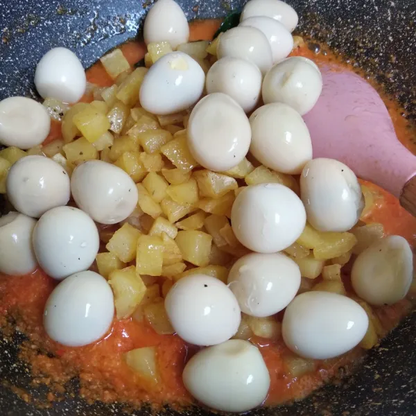 Masukkan kentang goreng dan telur puyuh, aduk rata.