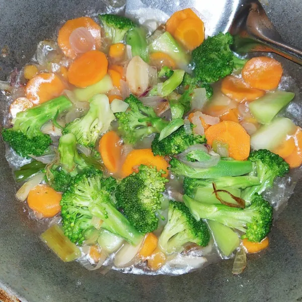 Panaskan margarin lalu tumis bawang bombay, bawang merah, jahe dan bawang sampai harum. Masukkan wortel dan tangkai brokoli tumis sebentar lalu masukkan air, tunggu mendidih masukkan brokoli.