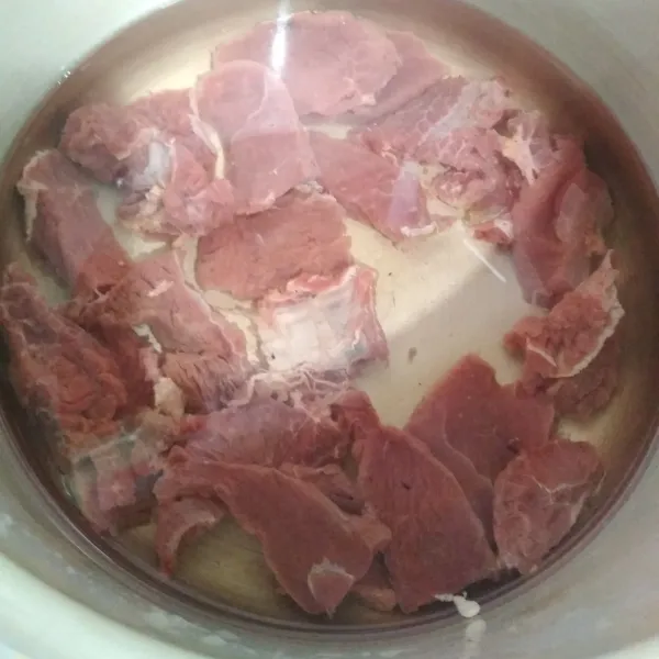 Rebus daging selama ± 5 menit lalu buang kotoran yang mengapung, angkat dagingnya.