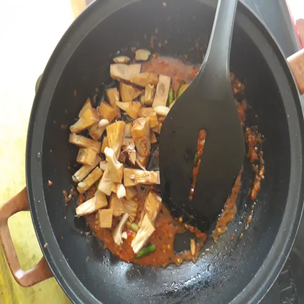 Masukkan gori yang sudah direbus. Tambahkan sedikit air. Beri garam dan koreksi rasa. Tutup wajan dan biarkan masak hingga bumbu menyerap.